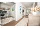 Bright hallway with hardwood floors, arched doorways, and a view of a home office and living space at 17228 River Race Dr, Huntersville, NC 28078