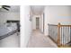 Upstairs hallway with wooden railing that leads to a bedroom and a bathroom, providing convenient access to different areas at 17228 River Race Dr, Huntersville, NC 28078
