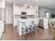 Bright kitchen with white cabinets, stainless steel appliances, and island with seating and modern pendant lighting at 17228 River Race Dr, Huntersville, NC 28078