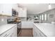 Modern kitchen with stainless appliances, white cabinets, island with countertop and living room in the background at 17228 River Race Dr, Huntersville, NC 28078