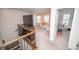 Second-floor living area boasting a TV, cream-colored sofa, and access to an exercise room, ideal for both relaxation and fitness at 17228 River Race Dr, Huntersville, NC 28078
