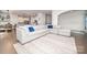 Bright and open living area with hardwood floors, a large sectional sofa, and views into the kitchen at 17228 River Race Dr, Huntersville, NC 28078
