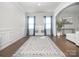 Spacious living room with hardwood floors, wainscoting, and elegant archways at 17228 River Race Dr, Huntersville, NC 28078