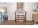 Staircase with a safety gate, wood steps and railing, leading to the upper levels of the home at 17228 River Race Dr, Huntersville, NC 28078