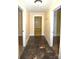 Well-lit hallway featuring neutral walls, and stylish flooring, leading to various rooms in the home at 175 Leonard Rd, Salisbury, NC 28146