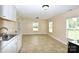 Eat-in kitchen featuring white cabinetry, tile floors and natural light at 175 Leonard Rd, Salisbury, NC 28146