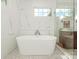 Bright soaking tub in bathroom with hexagon tile at 1814 Therrell Farms Rd, Waxhaw, NC 28173