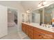 Spacious bathroom with double vanity, wood cabinets, and adjoined bedroom view at 1814 Therrell Farms Rd, Waxhaw, NC 28173
