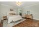 Serene bedroom with hardwood floors, a comfortable bed, and neutral decor, providing a relaxing atmosphere at 1814 Therrell Farms Rd, Waxhaw, NC 28173