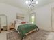 Neutral bedroom with modern chandelier, rug, and window at 1814 Therrell Farms Rd, Waxhaw, NC 28173