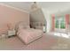 Bright bedroom featuring pink accents, patterned wallpaper, a cozy bed, and natural light at 1814 Therrell Farms Rd, Waxhaw, NC 28173