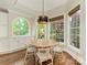 Cozy breakfast nook with a round table, lots of windows, and built-in storage at 1814 Therrell Farms Rd, Waxhaw, NC 28173