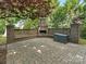 Brick patio featuring a brick outdoor fireplace with a seating area, and a storage box at 1814 Therrell Farms Rd, Waxhaw, NC 28173