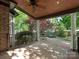 Inviting covered patio with wood ceiling, ceiling fan, and open view to brick patio and lush backyard at 1814 Therrell Farms Rd, Waxhaw, NC 28173