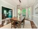 Elegant dining room featuring a large wooden table, stylish lighting, and ample natural light at 1814 Therrell Farms Rd, Waxhaw, NC 28173