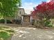 Beautiful brick home with an inviting entrance, stone walkway, and lush landscaping at 1814 Therrell Farms Rd, Waxhaw, NC 28173