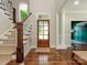 Bright foyer with hardwood floors, staircase, and a view into other rooms at 1814 Therrell Farms Rd, Waxhaw, NC 28173