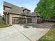 Spacious three car garage with brick exterior and a long driveway at 1814 Therrell Farms Rd, Waxhaw, NC 28173