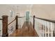 Hallway with dark hardwood floors and white railings at 1814 Therrell Farms Rd, Waxhaw, NC 28173