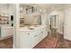 Bright kitchen with a white quartz island, hardwood floors, seamlessly connecting to the living and stairway area at 1814 Therrell Farms Rd, Waxhaw, NC 28173