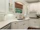 Well-lit kitchen featuring white cabinetry, stainless steel appliances, a tile backsplash, and a stainless steel sink at 1814 Therrell Farms Rd, Waxhaw, NC 28173