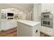 Open kitchen with an island, stainless steel appliances, and view into Gathering room at 1814 Therrell Farms Rd, Waxhaw, NC 28173