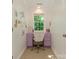 Compact office space featuring a stylish purple desk, window view, and comfortable seating at 1814 Therrell Farms Rd, Waxhaw, NC 28173
