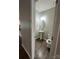 Cozy half bathroom features a pedestal sink, oval mirror, and wood-look flooring at 184 Cherry Birch St, Mooresville, NC 28117