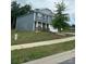 Charming two-story home with a landscaped front yard, blue siding, and stone accents under overcast skies at 184 Cherry Birch St, Mooresville, NC 28117
