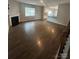 Living room has fireplace, wood floors, and an open concept to the kitchen at 184 Cherry Birch St, Mooresville, NC 28117