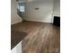 Open living room boasts wood floors, fireplace, and stairs to the second floor at 184 Cherry Birch St, Mooresville, NC 28117