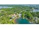 Aerial view of a lakeside estate with a private dock and boat slips surrounded by lush greenery at 18843 Flat Shoals Dr, Cornelius, NC 28031