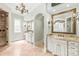 Luxurious bathroom with dual vanities, granite countertops, decorative mirrors, tile floors, and a glass shower at 18843 Flat Shoals Dr, Cornelius, NC 28031