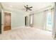 Large bedroom with a ceiling fan, an arched entryway, and a closet, offering comfort and convenience at 18843 Flat Shoals Dr, Cornelius, NC 28031