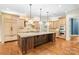 Gourmet kitchen boasts a center island, custom cabinetry, and professional-grade appliances, ideal for culinary enthusiasts at 18843 Flat Shoals Dr, Cornelius, NC 28031
