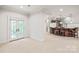 Spacious living room with French doors and a bar area with seating, great for entertaining guests at 18843 Flat Shoals Dr, Cornelius, NC 28031