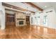Spacious living room features a stone fireplace, exposed wood beams, and built-in shelving, creating a cozy atmosphere at 18843 Flat Shoals Dr, Cornelius, NC 28031