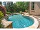 Custom-designed pool with stone accents and a waterfall feature, surrounded by lush landscaping at 18843 Flat Shoals Dr, Cornelius, NC 28031