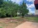 Large backyard featuring mature trees and a concrete slab at 2018 Rockycreek Ln, Monroe, NC 28112