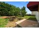 Spacious backyard featuring a concrete patio, trees, and a partially fenced perimeter at 2018 Rockycreek Ln, Monroe, NC 28112