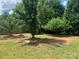Spacious backyard features mature trees and a level lot at 2018 Rockycreek Ln, Monroe, NC 28112