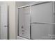 Bathroom featuring tiled walls, a glass shower door, and nice fixtures at 2018 Rockycreek Ln, Monroe, NC 28112