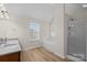 Primary bathroom with dual sink granite vanity, tub, shower, and natural light at 2018 Rockycreek Ln, Monroe, NC 28112