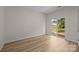 Bright bedroom with wood floors and a glass patio door leading to the backyard at 2018 Rockycreek Ln, Monroe, NC 28112