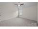 Bedroom featuring neutral carpet, a ceiling fan, and a bright window at 2018 Rockycreek Ln, Monroe, NC 28112