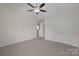 The bedroom includes a ceiling fan, carpet, and a closet for ample storage at 2018 Rockycreek Ln, Monroe, NC 28112