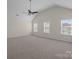 Spacious bedroom with neutral carpet, vaulted ceiling, and bright windows for natural light at 2018 Rockycreek Ln, Monroe, NC 28112