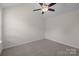 This bedroom features neutral carpet, a ceiling fan, and light-colored walls at 2018 Rockycreek Ln, Monroe, NC 28112
