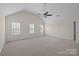Large bedroom with vaulted ceiling, three bright windows, and plush carpeting at 2018 Rockycreek Ln, Monroe, NC 28112