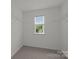 Walk-in closet features built-in shelving and a window at 2018 Rockycreek Ln, Monroe, NC 28112